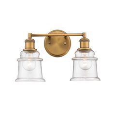 two light bathroom fixture with clear glass shades on the wall and gold finish, in an antique