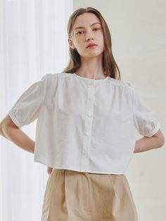 Softly structured, this effortless blouse.It is exceptionally soft and durable.Great outfits start here. - Meet our crisp and light weight blouse- Button up and round neck - It's less likely to wrinkle - Cropped length and rounded hem - Our fabric gives this shirt flexible comfort and it hugs your silhouette- Puff sleeve with buttoned cuffs Feminine Daywear Blouse With Button Cuffs, Effortless Blouse For Spring, Spring Crew Neck Blouse With Buttons, Summer Crew Neck Blouse With Button Closure, Effortless Button-up Top In A Specific Color, Effortless Solid Button-up Tops, Effortless Solid Color Button-up Tops, Relaxed Fit Crew Neck Top With Button Cuffs, Elegant Solid Color Everyday Blouse