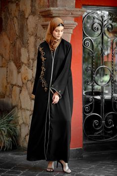 Premium Khaleeji Edition Open Abaya The Black Beaded Button Down Open Front Abaya is sophisticated and graceful! Featuring high quality nida fabric with perfectly placed beading on the chest and arms. You will be looking for an excuse to wear this beautiful abaya. Team it up with one of our dresses. 100% Nida Fabric Beaded Detailing Button Down Model is 5'5" and wearing size S Maternity Friendly Nursing Friendly Elegant Long Abaya With Dabka Work, Formal Floor-length Embroidered Abaya, Formal Abaya With Dabka Work For Eid, Elegant Embroidered Formal Thobe, Formal Eid Abaya With Dabka Work, Formal Long Abaya With Dabka, Elegant Long Abaya With Dabka Detail, Elegant Long Abaya With Dabka, Formal Floor-length Dabka Abaya