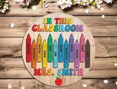 a wooden sign that says in this classroom, mrs smith with crayons on it