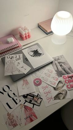 the desk is covered with many different types of paper and stickers, including clothes