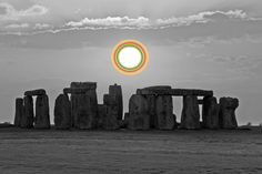 the sun is setting over stonehenge in black and white with an orange circle