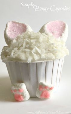 a cupcake with white frosting and pink ears