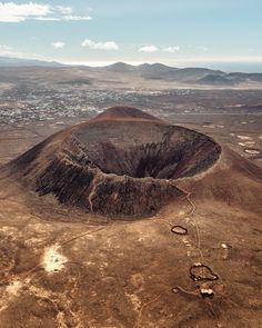 an aerial view of the desert with mountains in the background