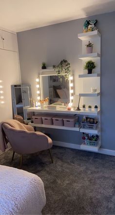 a bedroom with a bed, chair and vanity in the corner is lit up by lights