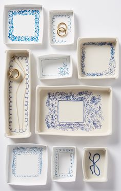 several trays with blue and white designs are arranged on the table, including scissors