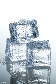 three ice cubes with water droplets on them