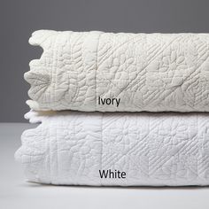 two white pillows stacked on top of each other with the words ivory and white written across them