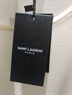 saint laurent paris label hanging on the back of a white shirt