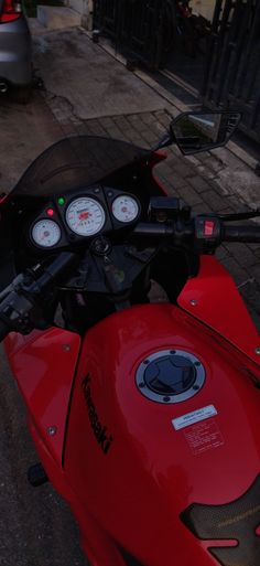 a red motorcycle is parked on the street