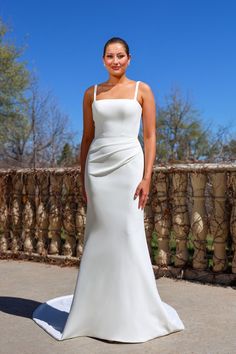 a woman in a white dress posing for the camera