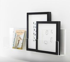 two black and white frames are hanging on the wall next to each other with pictures