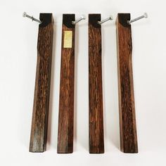 three pieces of wood sitting on top of each other in the shape of long poles