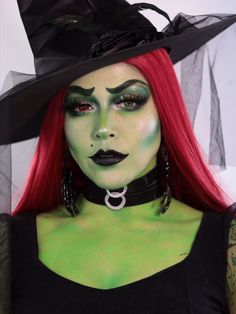 a woman with red hair and green makeup wearing a witch hat, black choker and matching necklace