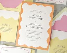 the wedding stationery is laid out on top of each other