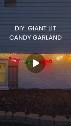 a house with christmas lights on it and the words diy giant lit candy garland