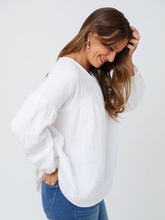 Cut from a soft, gauzy white cotton, this boho top makes every day feel like a beach day. There's something about an effortless statement earring that really brings out the best in this lightweight top with an easy fit. Fit Note: Designed to be roomy and flowy. Those that prefer a more fitted garment or that are in between sizes will want to size down 100% cotton Length of size M is 27" from top of bodice Made fair trade in India by one of our longstanding production partners Chic Beach Peasant Top With Relaxed Fit, Breezy Cotton Top For Day Out, Breezy Cotton Top For Vacation, Chic Relaxed Fit Peasant Top For Beach, Bohemian Cotton Gauze Top For Beach, Bohemian Tops With Relaxed Fit For Everyday, Bohemian Style Relaxed Fit Top For Everyday, Bohemian Relaxed Fit Top For Everyday, Relaxed Cotton Blouse For Vacation