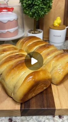 a loaf of bread sitting on top of a wooden cutting board