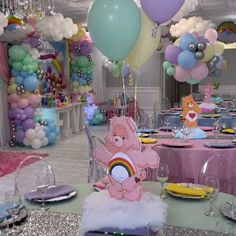 there is a table set up with balloons, plates and other items on the table