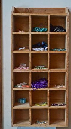 a wooden shelf filled with lots of different types of shoes and jewelry on top of it