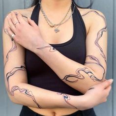 a woman with tattoos on her arms and chest