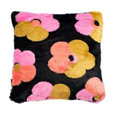 a black pillow with pink and yellow polka dots on it's side, sitting against a white background