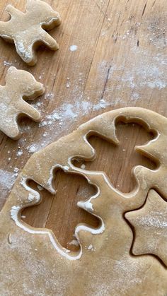 two cookies shaped like christmas trees on a wooden table