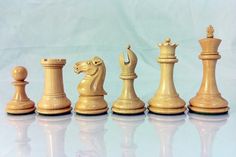 a set of chess pieces sitting on top of a table