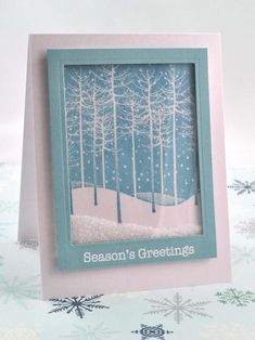 a greeting card with trees and snowflakes in the background that says season's greeting