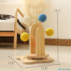 a wooden toy with three balls on it