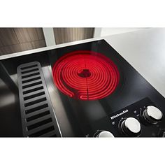 a stove top with a red burner on it's front and side burners