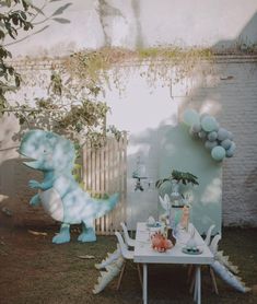 an outdoor party with balloons and decorations