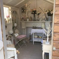 a room filled with lots of furniture and flowers on top of it's shelves