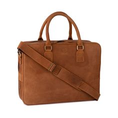 a brown leather briefcase with two straps on the front and side, sitting against a white background