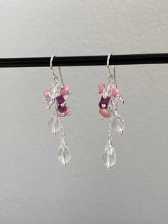 This pair of elegant shimmering sterling silver (925) drop earrings have been intricately crafted with beads hand wrapped onto silver and mounted like a cascade on a small silver chain. The stones are as follows: 2 faceted drops of rose quartz (size approx. 5 x 9 mm), 3 buttons each made of rhodochrosite (size 3 x 6 mm), 3 faceted beads made of rock crystal (diameter approx. 4 mm), 2 dice each of dark red, luminous ruby and 1 faceted button made of rhodochrosite (size approx. 3 x 4 mm). The earrings have a length of 5.5 cm. The ear hooks are 1.5 cm long, the pendants 4 cm. All silver parts used are sterling silver. The stones used as healing stones are also said to have a certain effect: Rose Quartz is the stone for the heart - it represents compassion, love, unconditional love, self-love Pink Sterling Silver Chandelier Earrings As A Gift, Pink Briolette Earrings With Natural Stones, Pink Briolette Natural Stone Earrings, Sterling Silver Chandelier Earrings With Natural Stones, Silver Gemstone Chandelier Drop Earrings, Silver Gemstone Drop Chandelier Earrings, Silver Sterling Chandelier Earrings With Natural Stones, Sterling Silver Natural Stone Chandelier Earrings, Elegant Wedding Earrings With Gemstone Beads