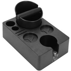 a black cup holder with three cups in it