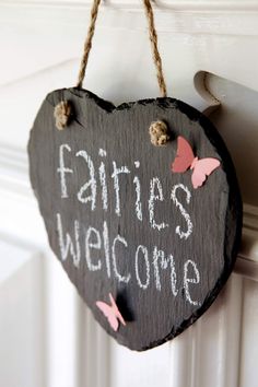 a heart shaped sign hanging from the side of a door