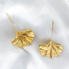 Introduce a touch of uniqueness with our Nicholls Drop Fan Earrings in Gold. The elegant fan-shaped design adds a statement to any outfit - perfect for a night out, holiday, or wedding. Made with nickel, lead, and cadmium-free materials, these drop earrings are both stylish and safe to wear. Approximate Total Drop Length 3.5" Festival Gold Plated Drop Earrings, Elegant Leaf-shaped Earrings For Party, Elegant Leaf-shaped Party Earrings, Leaf-shaped Metal Jewelry For Party, Elegant Leaf-shaped Earrings, Elegant Wing-shaped Earrings For Party, Elegant Wing-shaped Party Earrings, Wing-shaped Metal Jewelry For Parties, Leaf-shaped Metal Earrings For Party