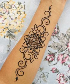 a woman's arm with a tattoo design on it