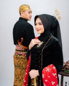 a man and woman dressed in traditional garb