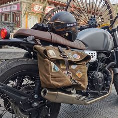 a motorcycle parked on the side of a road with a helmet on it's back