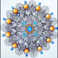 a drawing of an orange, blue and white flower with circles on it's center