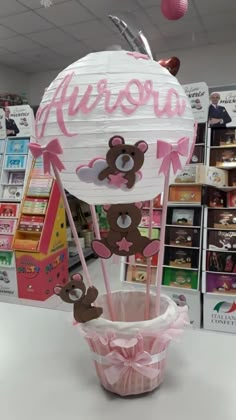 there is a paper cupcake in the shape of a hot air balloon with teddy bears on it