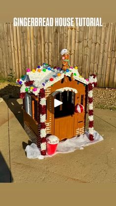 a gingerbread house made to look like it's been decorated for the holiday season