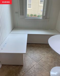 a white bench sitting next to a window in a room