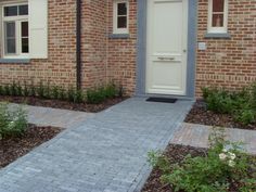 a brick house with white doors and windows