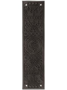 a decorative door with an intricate design on the front and back panel, in dark brown