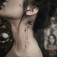 a woman's neck with a star tattoo on it