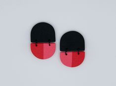 pair of black and red earrings on white background