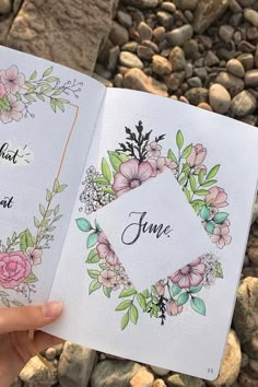 someone is holding up an open book with flowers on it and the words june written in cursive writing